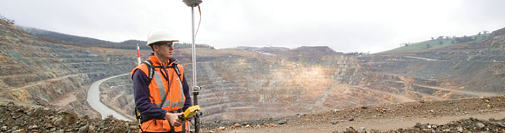 Surveyor in open cut mine